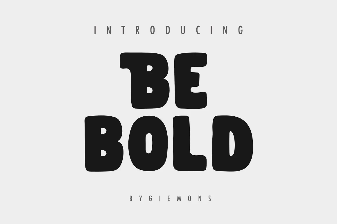 Be Bold Font is a heavy display typeface with wide blocky proportions, thick monolinear strokes, and rounded corners.
