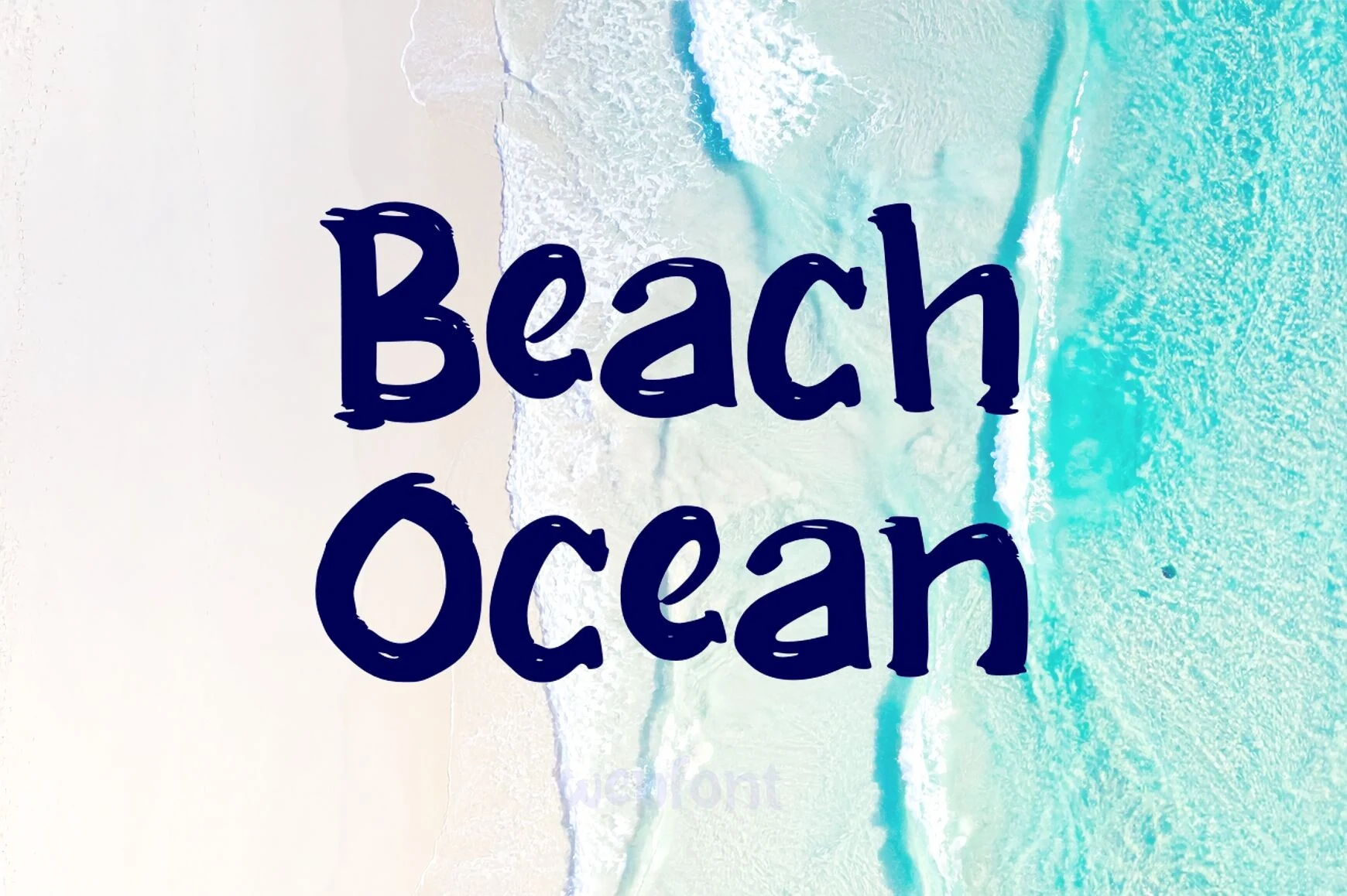 Beach Ocean Font preview with dark blue playful hand-drawn lettering over an aerial beach shoreline