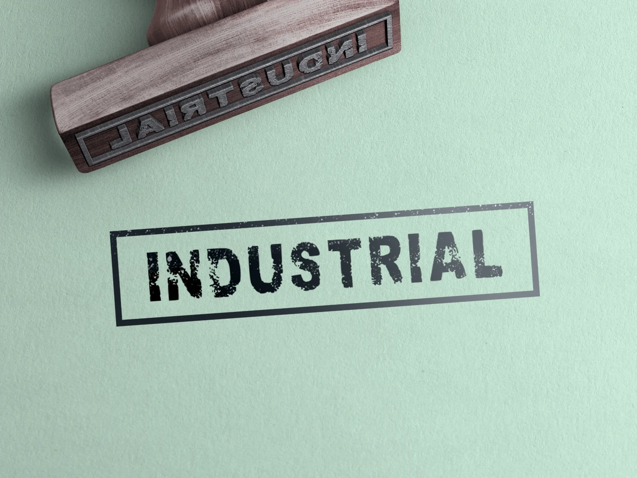 Industrial Font preview with distressed bold uppercase stamp-style lettering inside a rectangular border